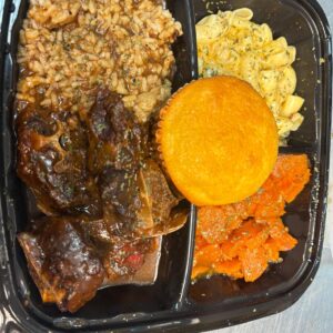 Oxtail Plate served with Yams Mac N' Cheese and cornbread